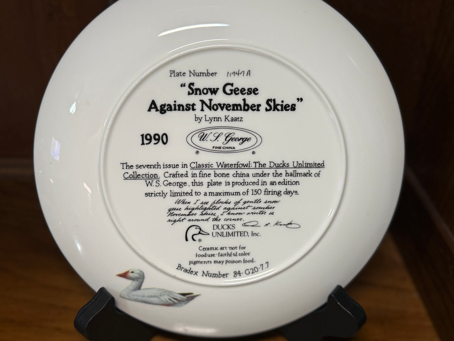 Ducks Unlimited Snow Geese Against November Skies ceramic plate by Lynn Kaatz, featuring snowy geese in flight artwork.