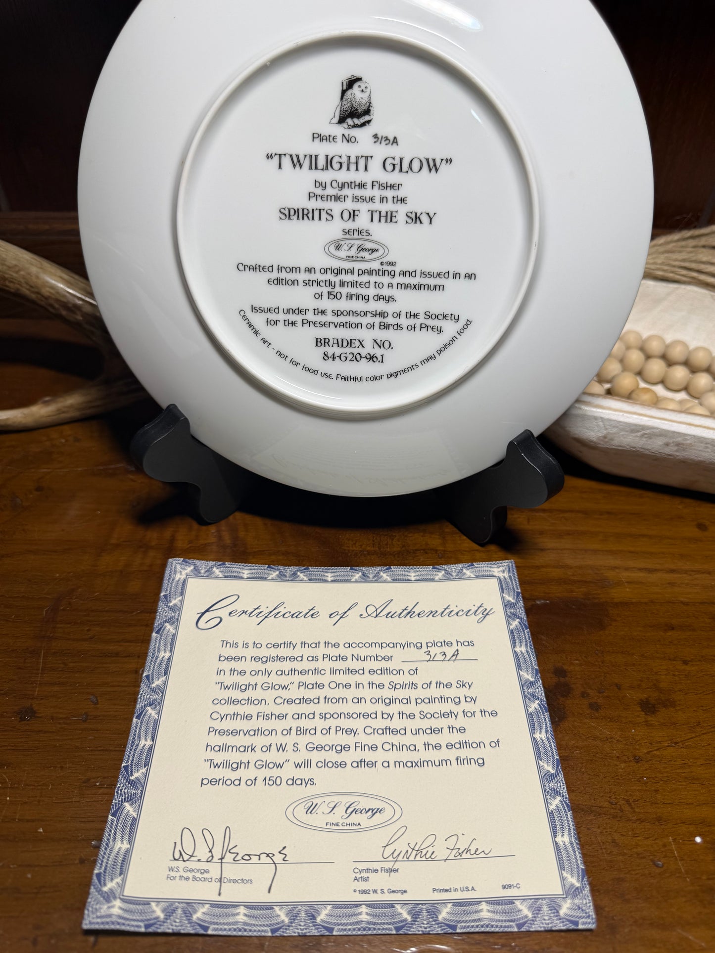 "Wild Feathered Finds 'Twilight Glow' Snowy Owl collector plate by Cynthie Fisher, featuring snowy owl design with certificate of authenticity"