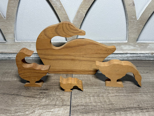 Hand-carved wooden goose family display set by Wild Feathered Finds, featuring vintage farm animal decor with detailed craftsmanship.