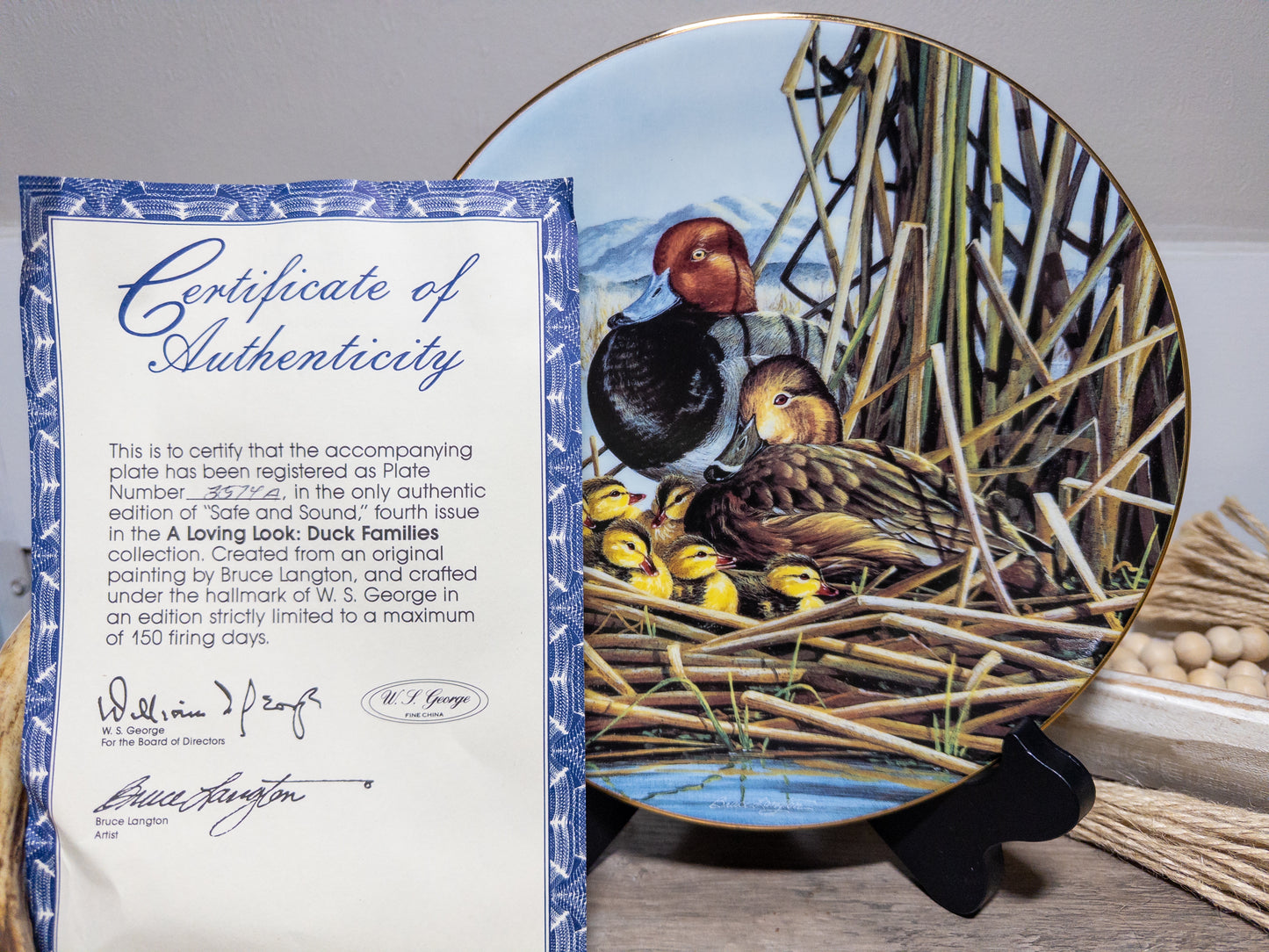 Wild Feathered Finds "Safe and Sound" Redhead Duck Family collector plate by Bruce Langton, featuring a detailed duck family illustration.