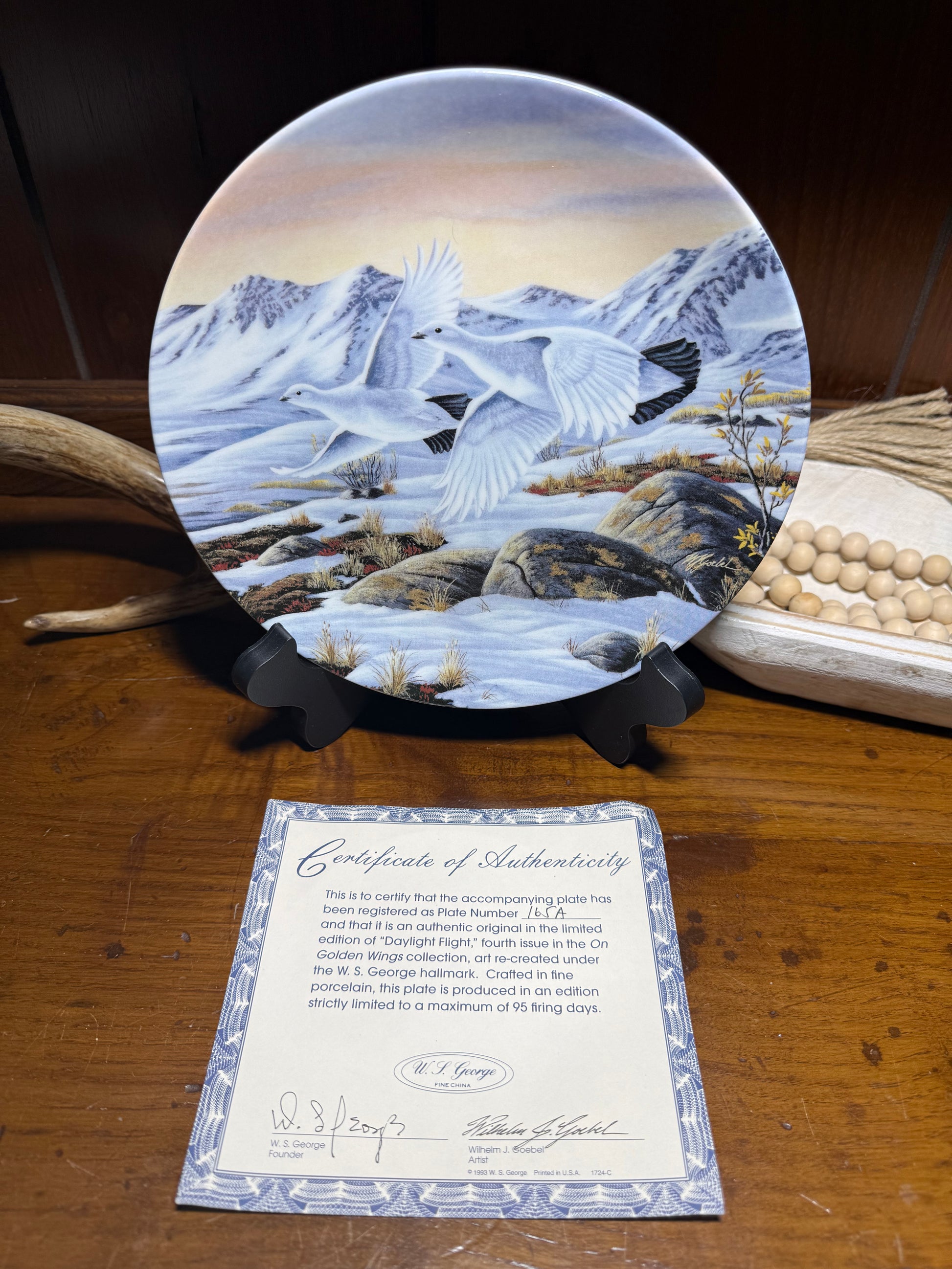 Daylight Flight Snow Goose collector plate by Wilhelm J. Goebel, featuring golden wings and a COA, displayed on a neutral background
