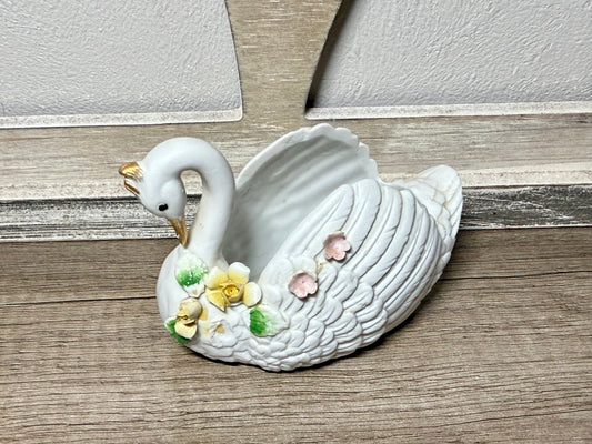 Vintage white ceramic swan planter with floral details, ideal for cottagecore decor and floral arrangements.
