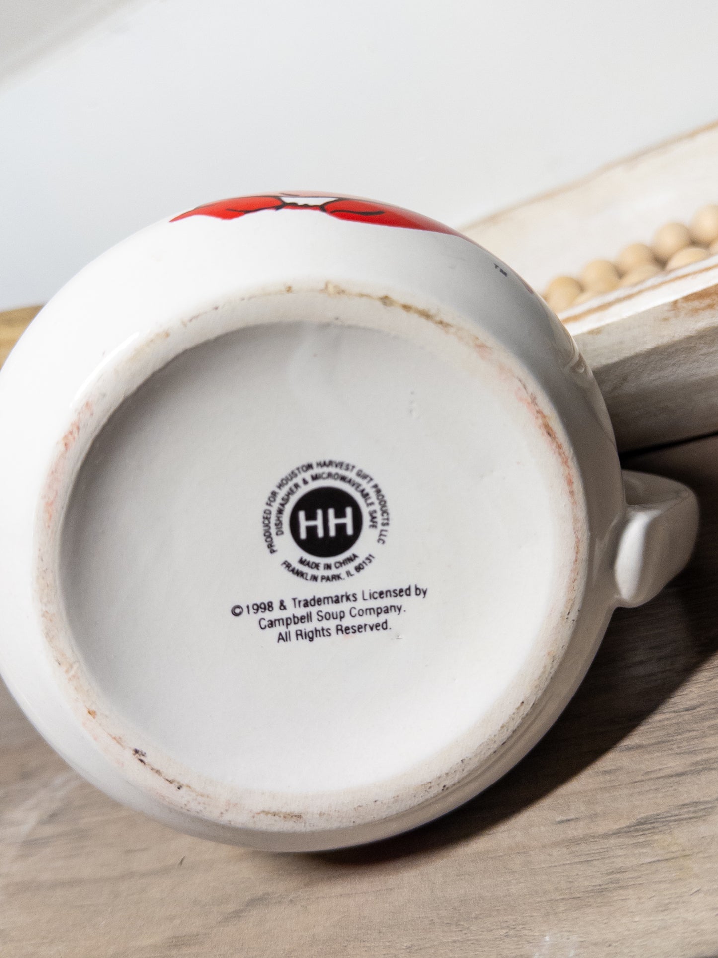 Vintage Campbell Soup Kids mug with Houston Harvest design, ceramic cup featuring colorful soup can illustration and licensed 1998 branding.