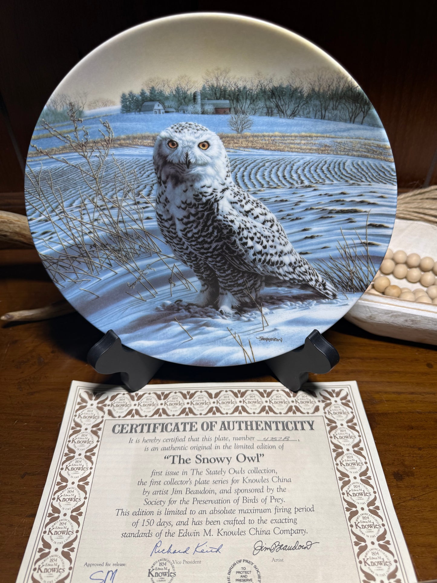 Wooden plate featuring "The Snowy Owl" by Jim Beaudoin from Wild Feathered Finds, with detailed owl illustration and Knowles China mark.