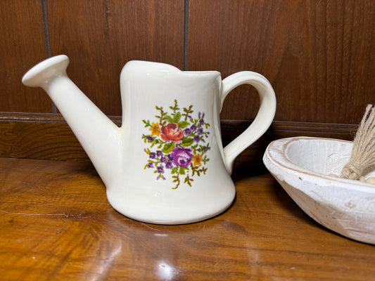 Vintage ceramic watering can planter in floral cottage style with cream glaze, featuring a pitcher shape and decorative floral details.