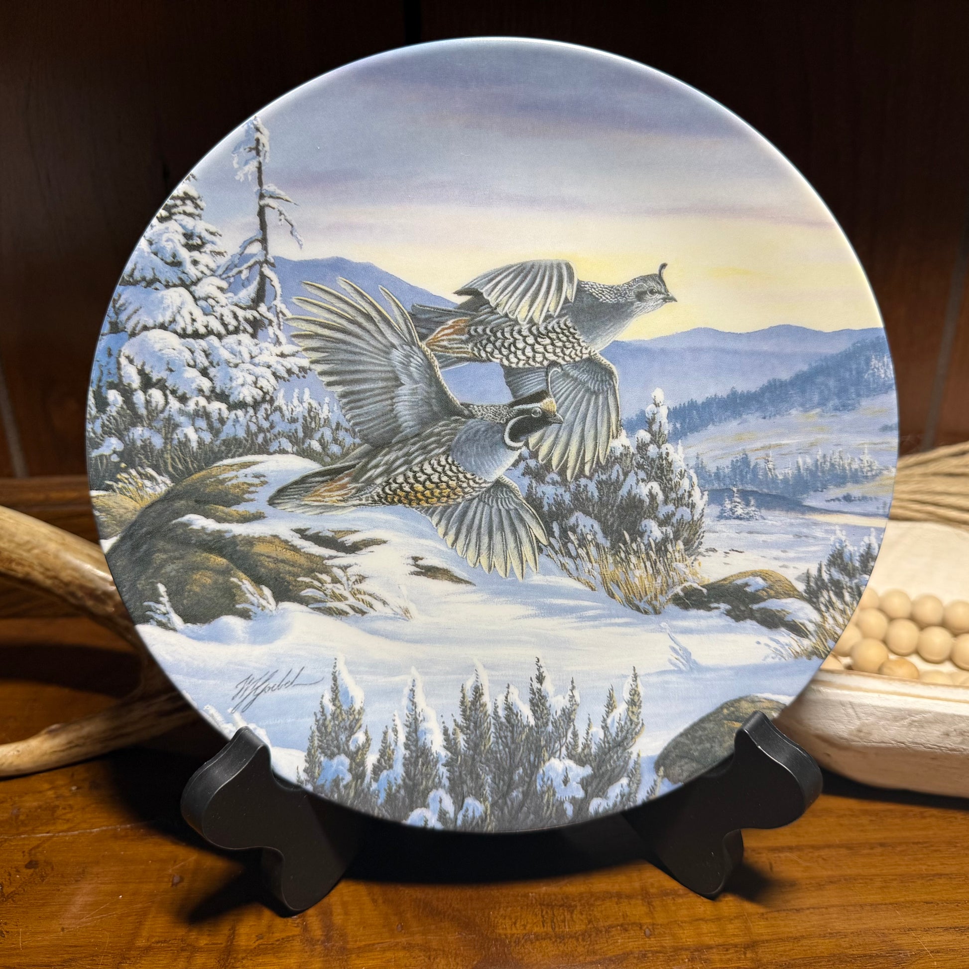 "Wild Feathered Finds 'Winter Dawn' Plate #399A by Wilhelm J. Goebel featuring a winter scene with golden accents and detailed artwork."