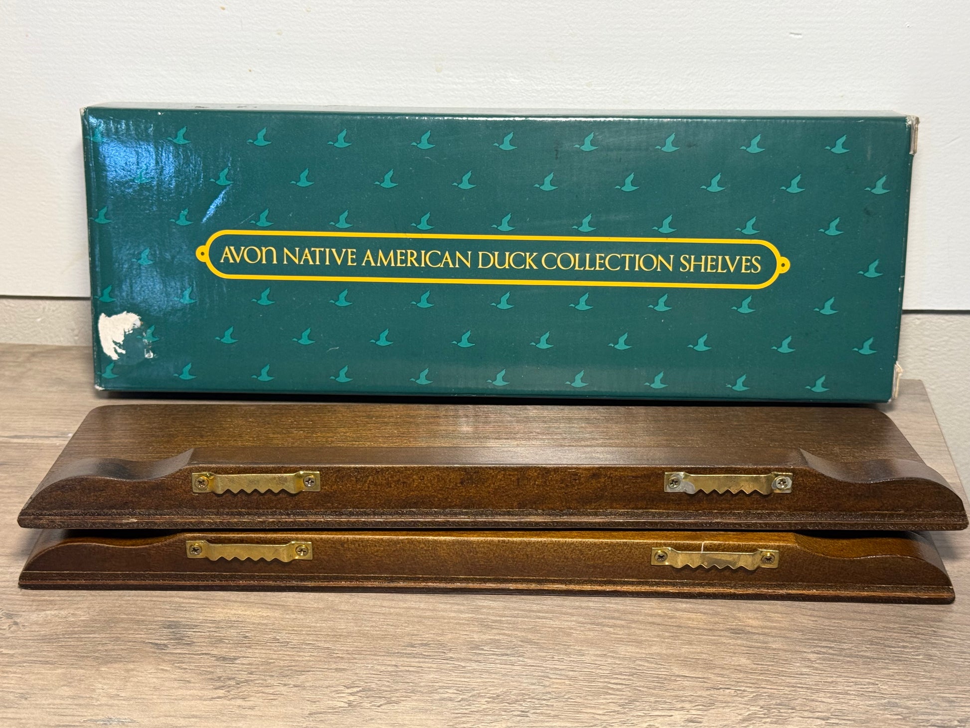 Vintage Avon duck collection display shelves set of 2 wood wall shelves with decorative duck figures and storage boxes.