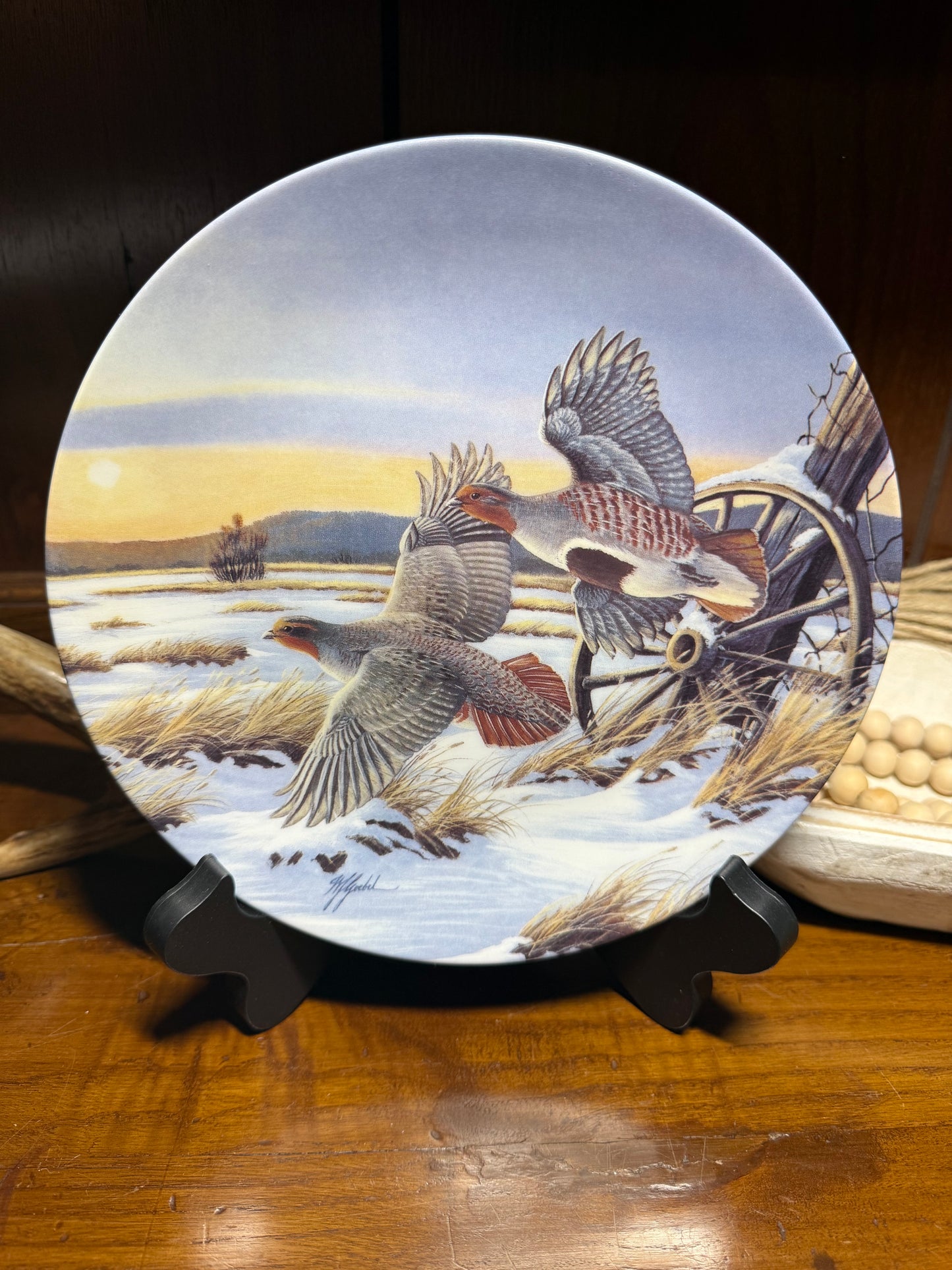 "Wild Feathered Finds 'First Light' wildlife collector plate by Wilhelm J. Goebel, featuring golden wings and a certificate of authenticity."