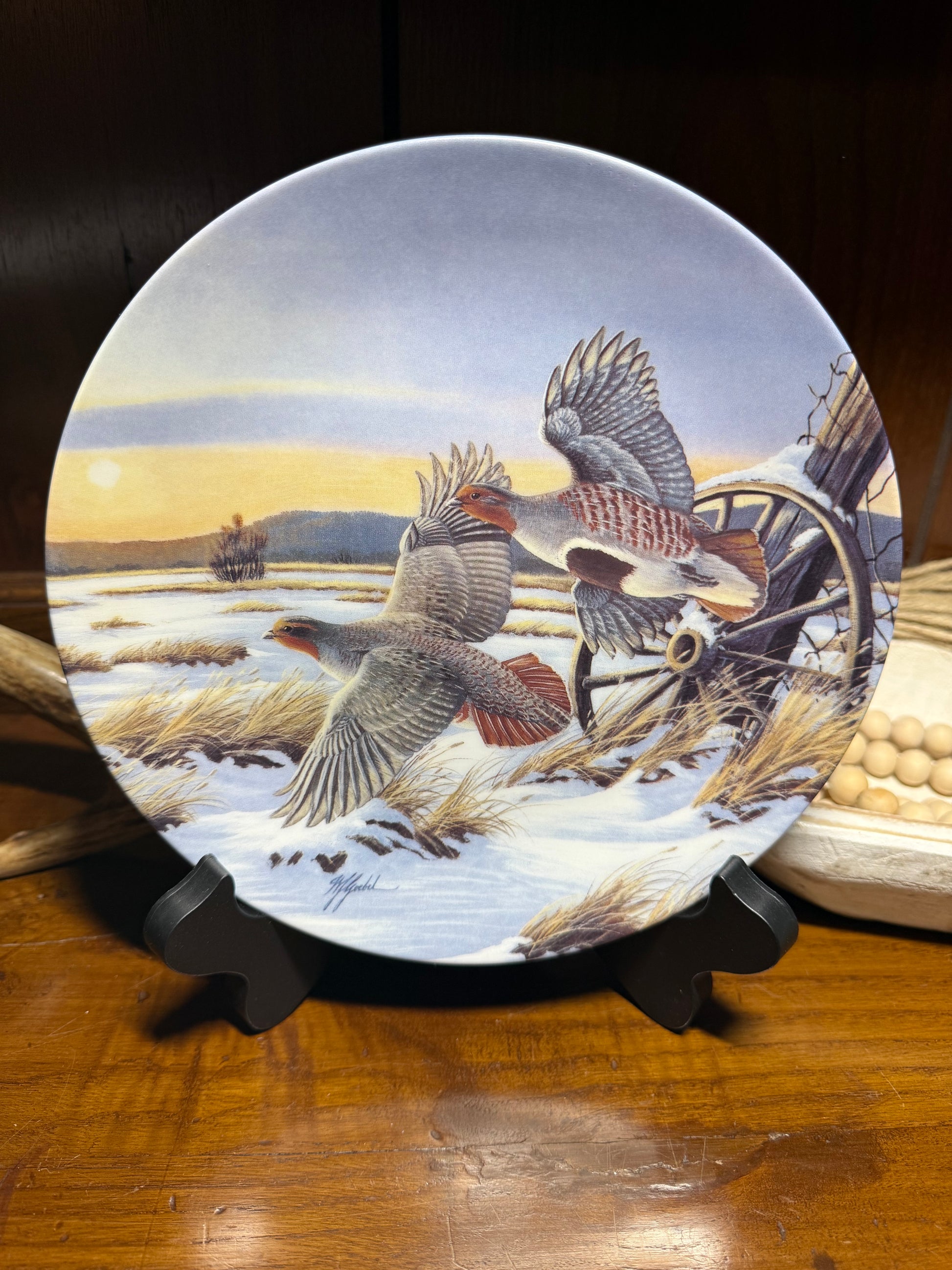 "Wild Feathered Finds 'First Light' wildlife collector plate by Wilhelm J. Goebel, featuring golden wings and a certificate of authenticity."