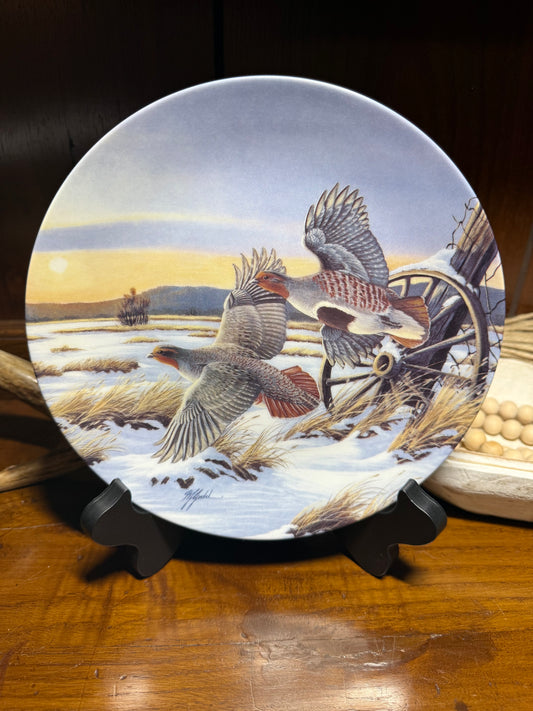 "Wild Feathered Finds 'First Light' wildlife collector plate by Wilhelm J. Goebel, featuring golden wings and a certificate of authenticity."