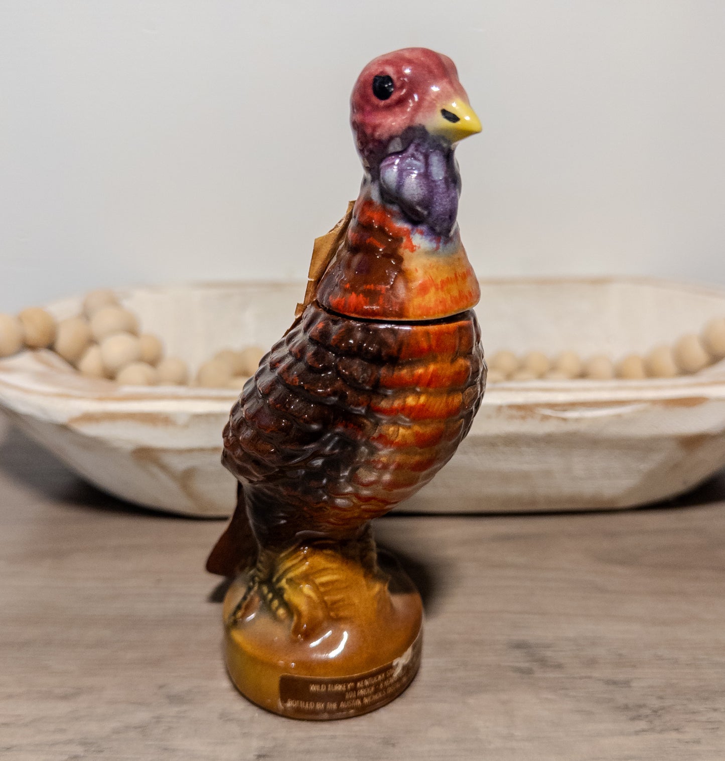 Vintage Wild Turkey ceramic decanter displaying a 1970s bourbon bottle with Wild Feathered Finds branding and detailed ceramic design.