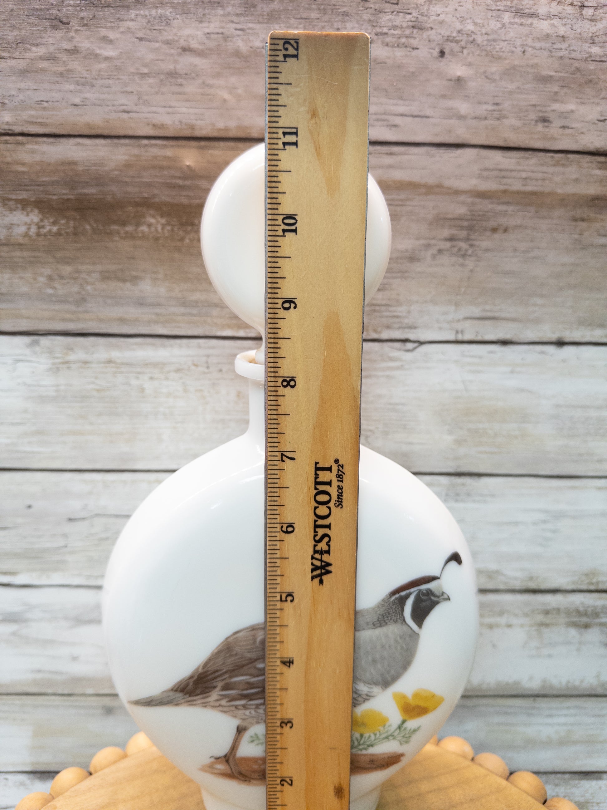 Vintage 1969 Wild Feathered Finds California Quail whiskey decanter by Dant Distillery, made of milk glass with detailed bird design.